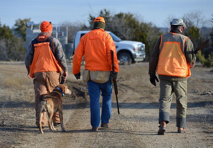 hunters with a guide in the field