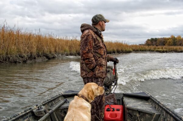 What safety precautions should you take when hunting from a boat